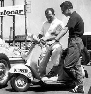 Stirling Moss trying a Vespa scooter out for size
