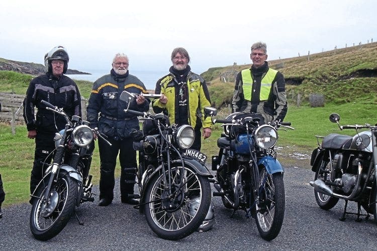 Joe Gray and Frank Johnson, in the centre with the baton, at the end of the public road on Unst, which is as far north in the UK as you can get. 