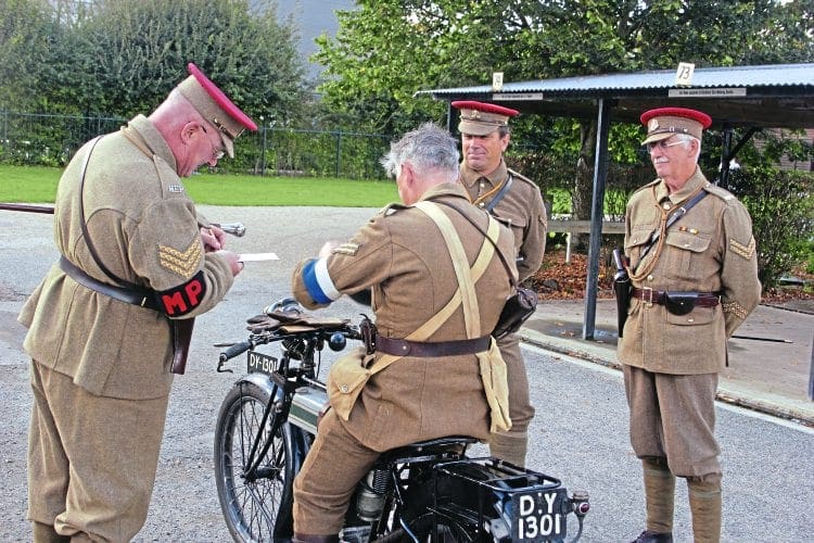 Peter Birkett has obviously done something to upset the red-caps while riding his Triumph Model H. 