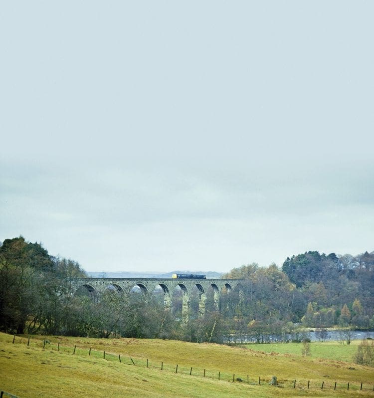 A DMU for Alston crosses Lambley Viaduct on April 17, 1976.