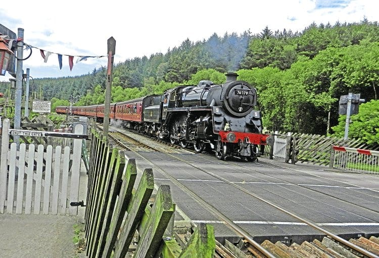 NYMR’s rocket: BR Standard Class 4MT 2-6-0 No. 76079, nicknamed the ‘Pocket Rocket’, pulls into Levisham station on the North Yorkshire Moors Railway on July 13 with the 2pm Whitby-Pickering train. The station house is being converted into a holiday let by Chris Ware, the line’s artist in residence, who has a studio in the historic property. GEOFF COURTNEY 