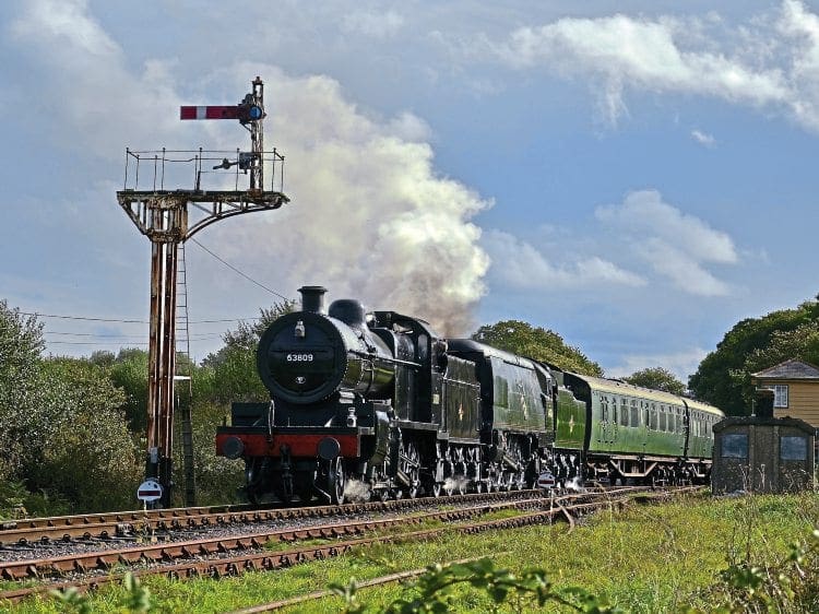 No. 53809 and No. 34070 Manston depart from Harmans Cross. JAMES CORBEN