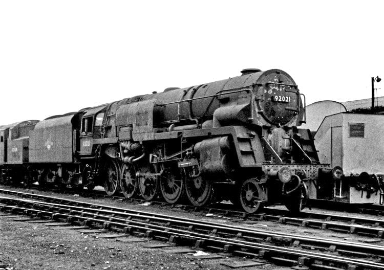 One of the modified Franco-Crosti boilered 9Fs, No. 92021, with smoke deflector added around the final chimney. It was the drifting smoke problem with the original 10 locomotives that necessitated the diversion to Wellingborough in December 1955 of Nos. 92060-92066, which had been earmarked for Tyne Dock. No. 92021 is looking in a very sorry state at Derby shed on April 24, 1960.