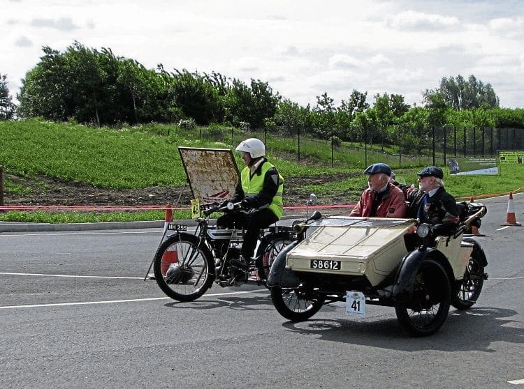 Philip Barfield (1910 Triumph) and Keith Norton and passenger in the 1911 AC Sociable tackle the roadworks outside the museum.