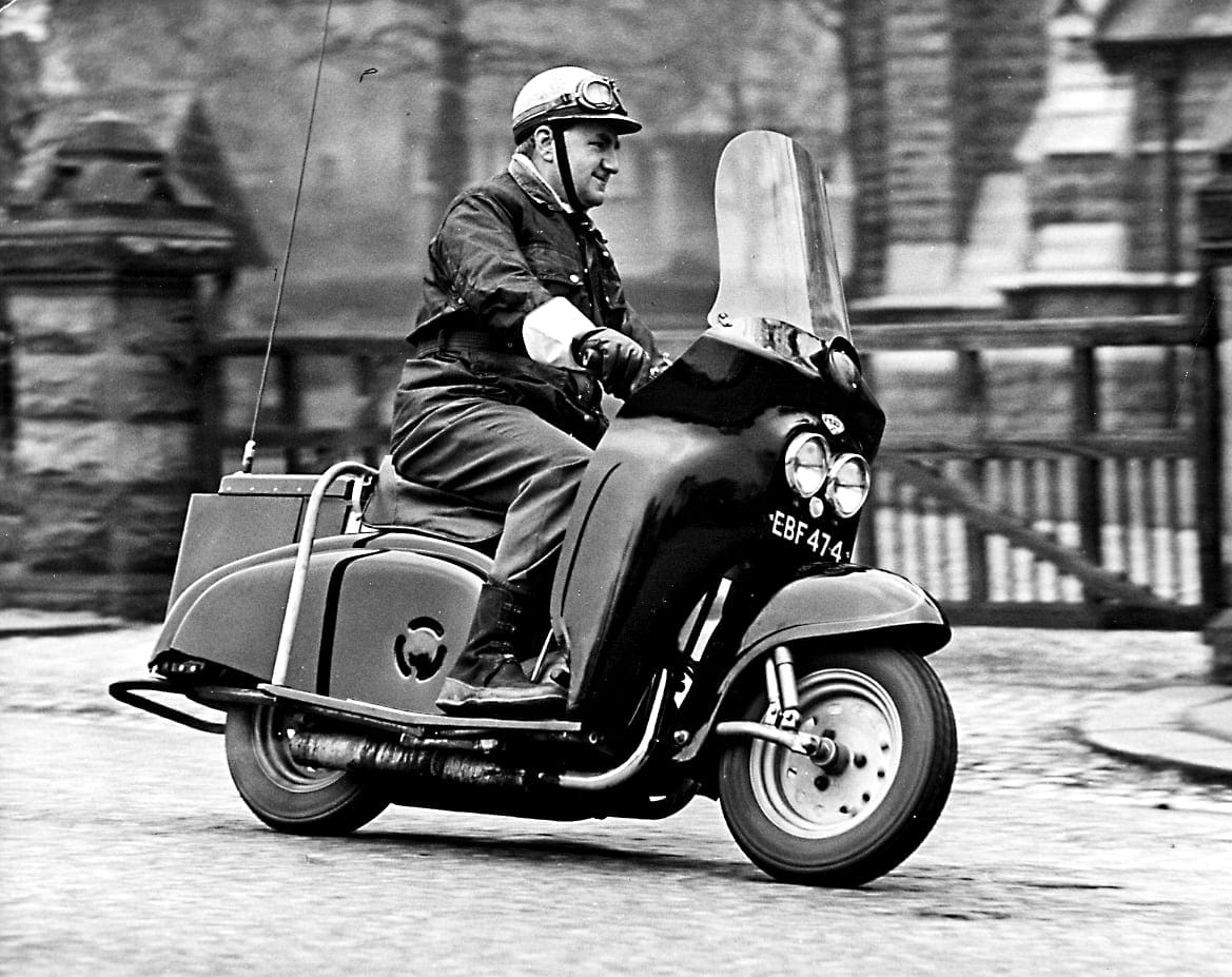 The late lamented Bob Currie looks comfortable as he tries out a 249cc Villiers two-stroke twin-powered DMW Deemster, neither scooter nor motorcycle, in the early 1960s. The model was adopted for rural patrol duties by several constabularies in Wales and the Midlands, and a later version was powered by the Velocette Viceroy flat-twin two-stroke engine.