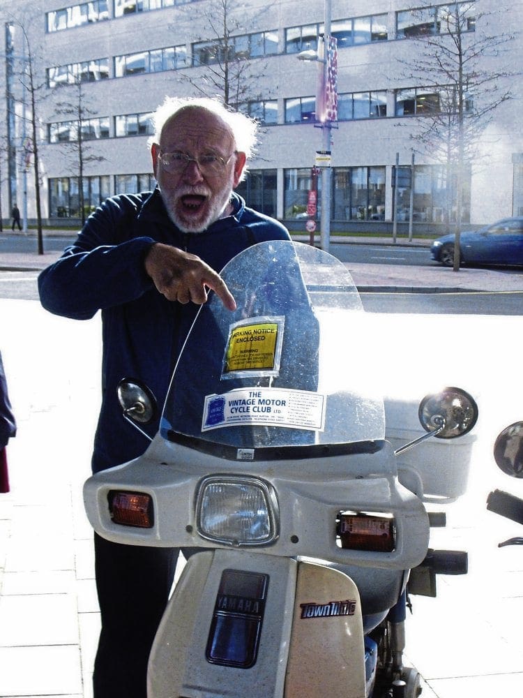 Mortified! One of the Wobblers points to the parking ticket on his Yamaha Town Mate.