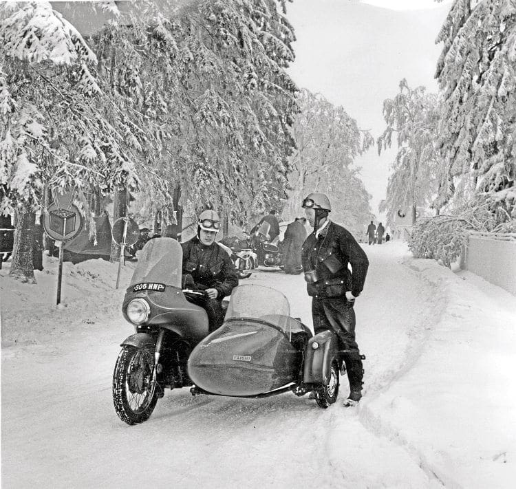 It’s not quite so summery as Motor Cycle’s Peter Fraser and Bill Banks try out a new Royal Enfield Constellation and Swallow sidecar as they head to the 1963 Elephant Rally in Germany.