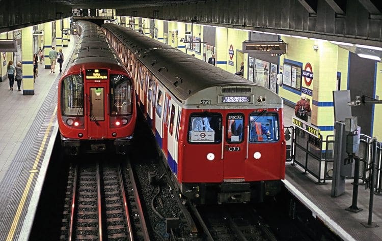 ‘C’ Stock No. 5721 calls at Aldgate East on June 29, 2014, while forming the type’s farewell railtour – passing one of its replacement ‘S7’ Stock sets on Hammersmith & City Line duties.  James Sutcliffe 