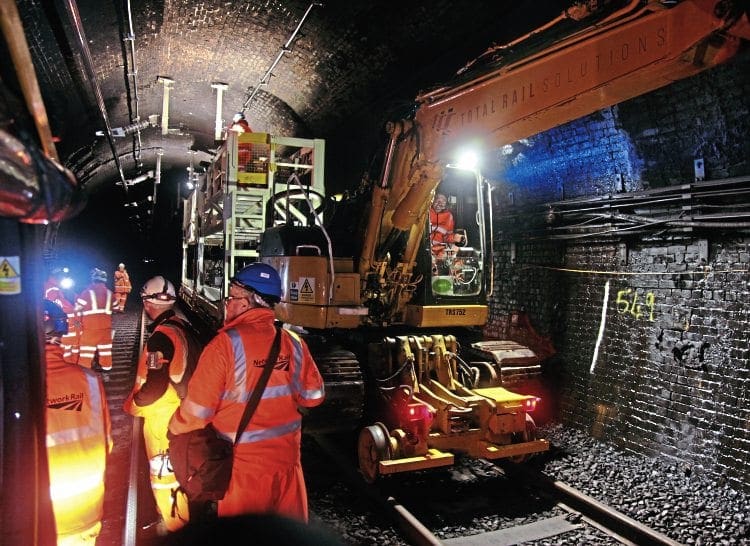 Electrification of the Severn Tunnel was running to plan on October 3, just over halfway through the 40-day blockade. Seven thousand auto transformer feeders were being installed to feed the 14km (8.75 mile) of overhead rigid conductor rail, with road-rail vehicles used to move elevated work platforms through the tunnel. One of the work sites some two kilometres from the English portal is pictured that day. Phil Marsh