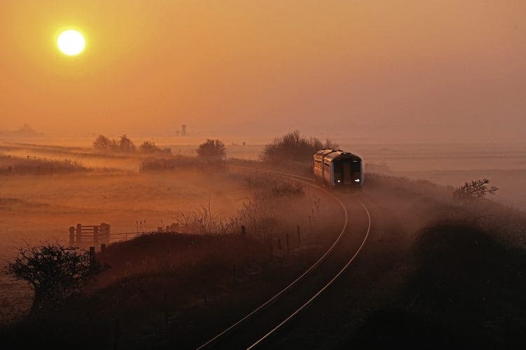 WHERRY DAWN: Low sun and misty fields combine to great effect as a Greater Anglia Class 156 heads towards Acle, Norfolk, with a Great Yarmouth to Norwich service on March 12, 2014. Steve Arthur