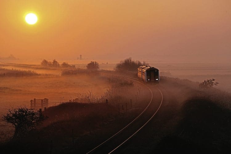 WHERRY DAWN: Low sun and misty fields combine to great effect as a Greater Anglia Class 156 heads towards Acle, Norfolk, with a Great Yarmouth to Norwich service on March 12, 2014. Steve Arthur 