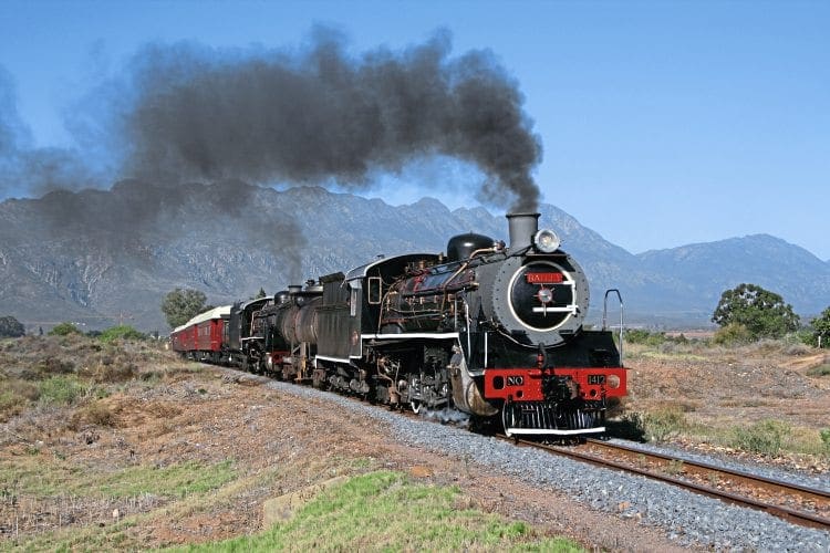 The new owner of the line through Michell’s Pass – Transnet Freight Rail – has given its locos names: Ceres Railway coal-fired Class 19B No. 1412 (Berliner Maschinenbau 9838/1930) Bailey plus oil-burning Class 19D No 3321 Jessica (North British 1948/26041) are seen working en route from Voorbaai to Ceres via Worcester on March 14. No. 1412 had just been overhauled in Voorbaai for Ceres Rail by Transnet, and this special train was used to move it to its new home. JEAN DULEZ