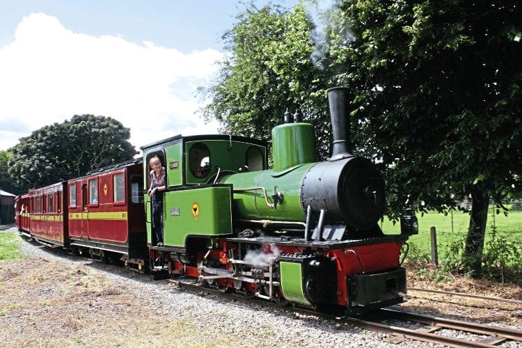 O&K 0-6-0WT Pedemoura pulls its first passenger train away from Leighton Buzzard Railway’s Page’s Park station on July 17. Driver David Fisher, a member of the owning group and de facto restoration project leader, is understandably looking very happy. WILLIAM SHELFORD