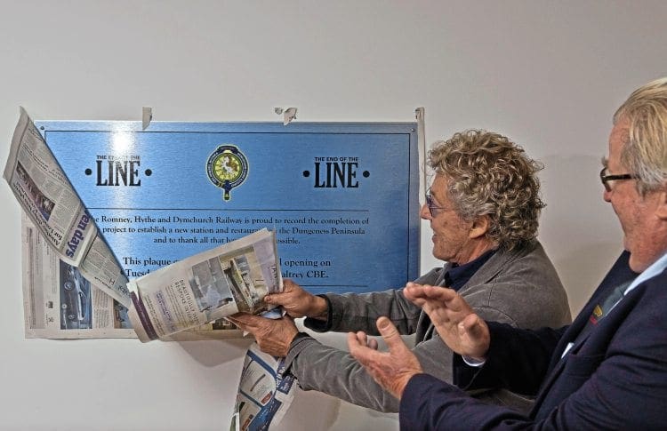 Roger Daltrey tears away the covering to unveil the plaque commemorating the official opening of the rebuilt RH&DR Dungeness station as Sir William McAlpine looks on. STEVE TOWN/ROMNEY, HYTHE & DYMCHURCH RAILWAY 