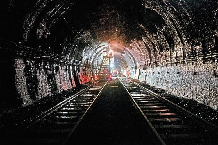 The Severn Tunnel will be home to Network Rail engineers for six weeks from September 12 as they install overhead line equipment for the GWML electrification. Here, they are seen performing preparatory work to remove layers of built-up soot and ash. NETWORK RAIL