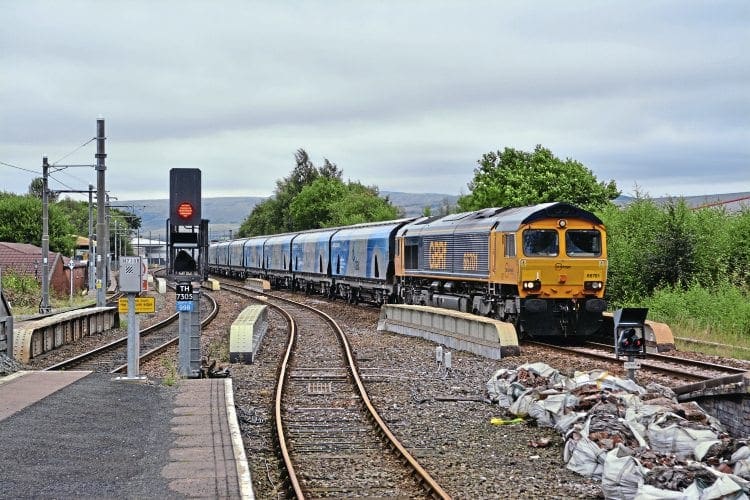 On September 5, GBRf Class 66 No. 66701 eases the 4M51 Drax Power Station to Liverpool empty biomass hoppers through the new Rochdale station, which is currently still under construction. STEVE BURDETT 