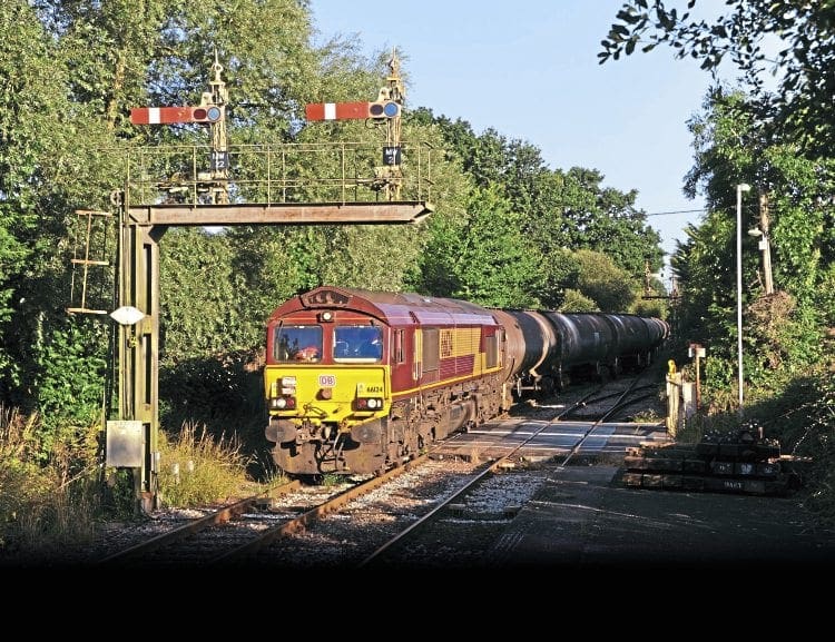 On August 8, 2016, DB Cargo’s No. 66124 passes under the signal gantry at Marchwood with crude oil from Holybourne to Fawley. The driver has given his loco a home-made headboard slightly prematurely named ‘Fawley Finale’, but we are grateful to him for giving us a title for this article. Marchwood at 86.15 is the junction for the MoD port at Cracknore Hard, on Southampton Water, which will keep this part of the Fawley branch in business for the foreseeable future, especially if potential lessee Solent Gateway develops a civilian side, which could generate new rail traffic. Manual signalling predominates, almost unique on Network Rail in southern England these days. RALPH MONTAGU 