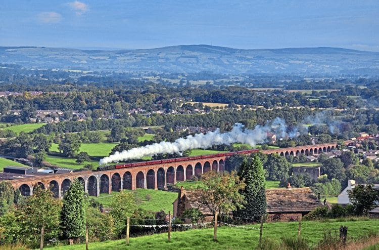 The length of the Whalley Arches is shown to good effect as Carnforth-based ‘Royal Scot’ No. 46115 Scots Guardsman crosses the structure with the ‘Lune Rivers Trust Special’ to Chester on September 4, 2010. The viaduct will undergo major strengthening and draining work. BOB GREEN