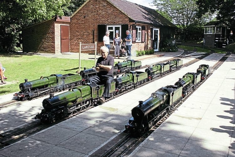 Tony Newberry pictured on ‘King’ class 4-6-0 No. 6026 King John, completed in 1992. He is surrounded by some of his locos, gathered together from various owners and railways, at Coate Water Miniature Railway on August 13. PETER NICHOLSON 