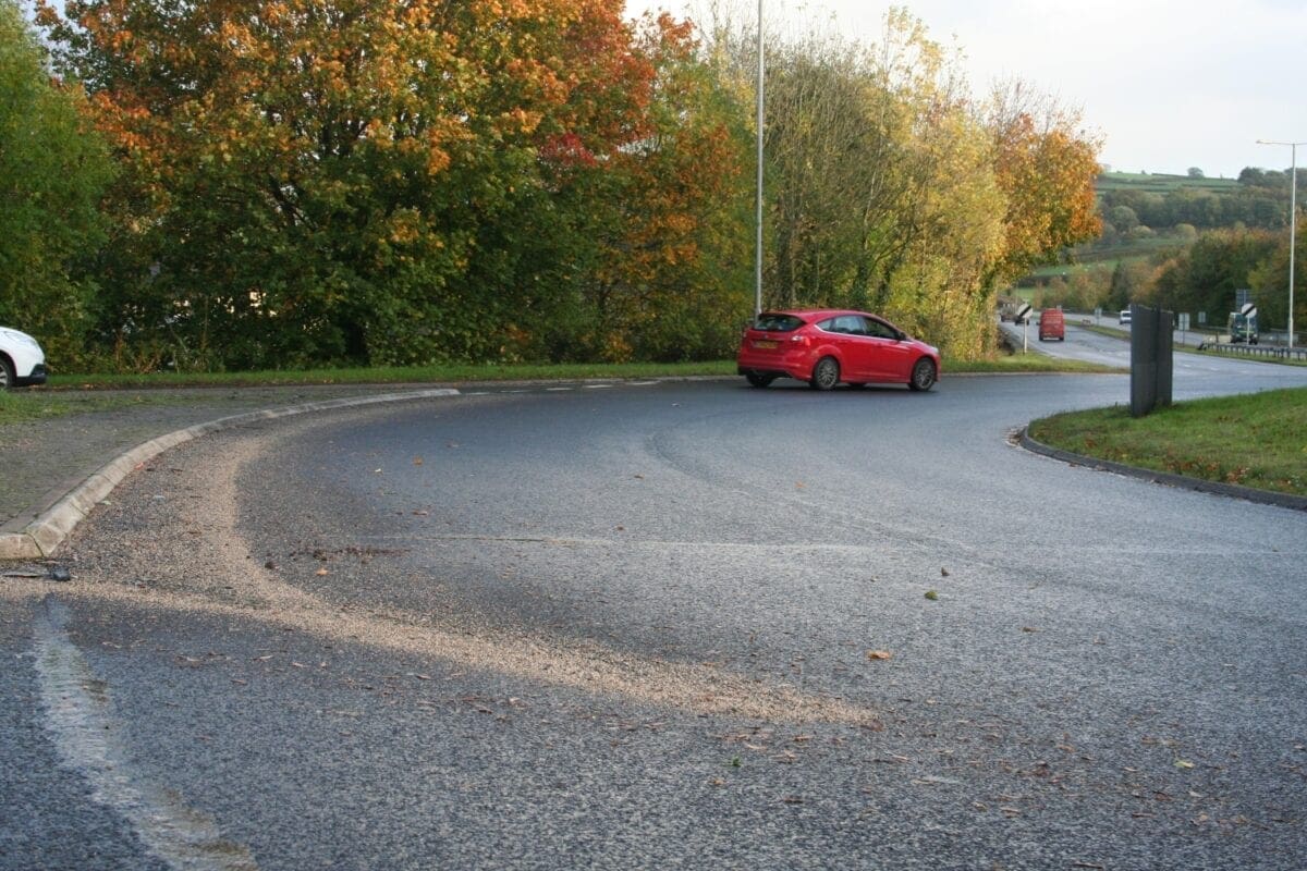 Spot the loose grit, swept into a pile by passing traffic