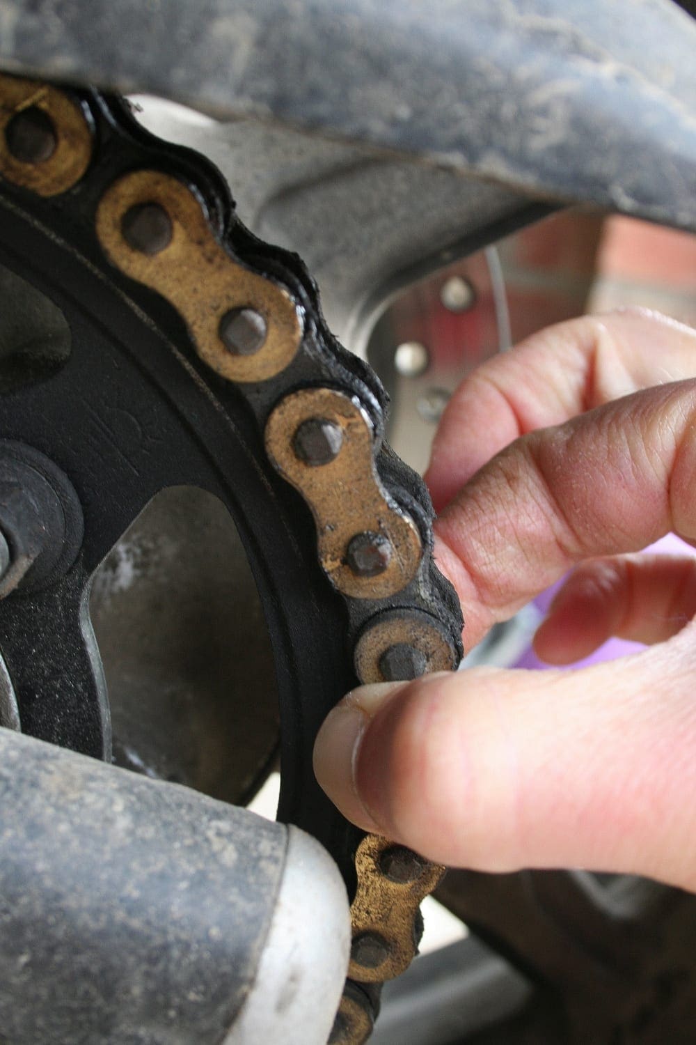 Check chain wear by pulling it away from the sprocket